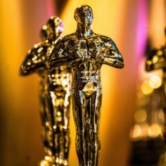 a number of oscar statues on a table